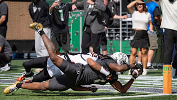 Oregon Ducks wide receiver Dakorien Moore dives in for a touchdown under coverage from Oregon State Beavers defensive back Jalil Tucker as the Oregon Ducks host the Oregon State Beavers Sept. 20, 2025, at Autzen Stadium in Eugene, Oregon.