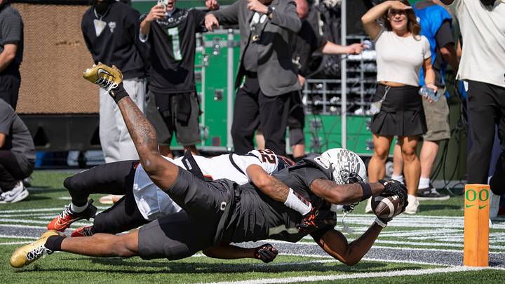 Oregon Ducks wide receiver Dakorien Moore dives in for a touchdown under coverage from Oregon State Beavers defensive back Jalil Tucker as the Oregon Ducks host the Oregon State Beavers Sept. 20, 2025, at Autzen Stadium in Eugene, Oregon.