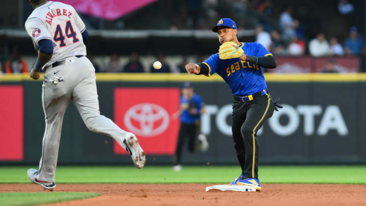 Seattle Mariners second baseman Jorge Polanco (right) throws the ball to first base to against the Houston Astros on Friday at T-Mobile Park.