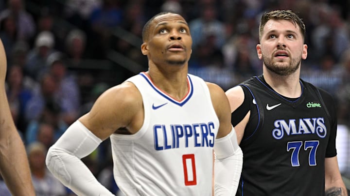 May 3, 2024; Dallas, Texas, USA; LA Clippers guard Russell Westbrook (0) and Dallas Mavericks guard Luka Doncic (77) look for the ball on a foul shot during the first quarter during game six of the first round for the 2024 NBA playoffs at American Airlines Center. 