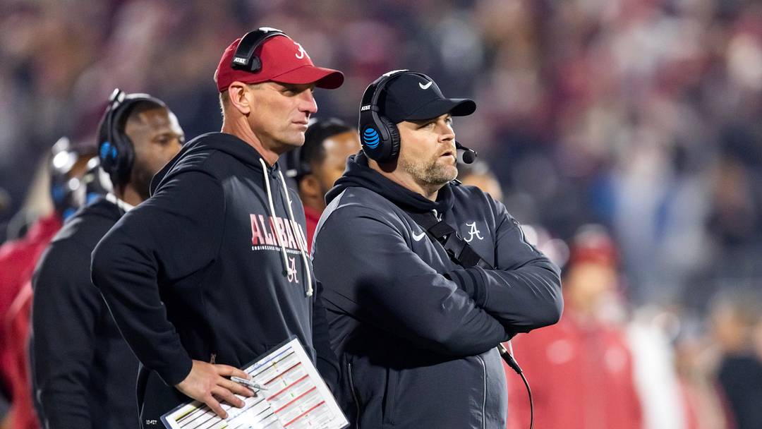 Dec 19, 2025; Norman, OK, USA; Alabama Crimson Tide head coach Kalen Deboer (left) and defensive coordinator Kane Wommack against the Oklahoma Sooners during the CFP National Playoff First Round at Gaylord Family Oklahoma Memorial Stadium. Mandatory Credit: Mark J. Rebilas-Imagn Images