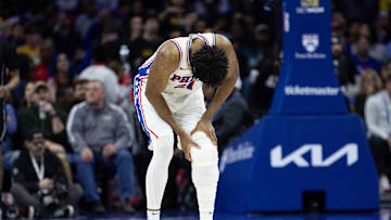 Feb 22, 2025; Philadelphia, Pennsylvania, USA; Philadelphia 76ers center Joel Embiid (21) holds his leg after a play against the Brooklyn Nets during the second quarter at Wells Fargo Center. Mandatory Credit: Bill Streicher-Imagn Images