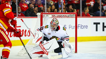 Nov 7, 2025; Calgary, Alberta, CAN; Chicago Blackhawks goaltender Spencer Knight (30) guards his net against Calgary Flames center Morgan Frost (16) during the second period at Scotiabank Saddledome. Mandatory Credit: Sergei Belski-Imagn Images