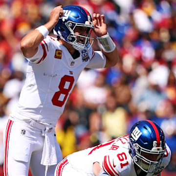 Sep 15, 2024; Landover, Maryland, USA; New York Giants quarterback Daniel Jones (8) signals at the line of scrimmage against the Washington Commanders at Commanders Field. Mandatory Credit: Peter Casey-Imagn Images