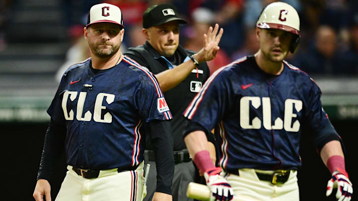 Cleveland Guardians manager Stephen Vogt, left, gets between center fielder Lane Thomas (8) and home plate umpire Adam Hamari after Thomas struck out during the eighth inning against the Texas Rangers at Progressive Field on Aug 23.