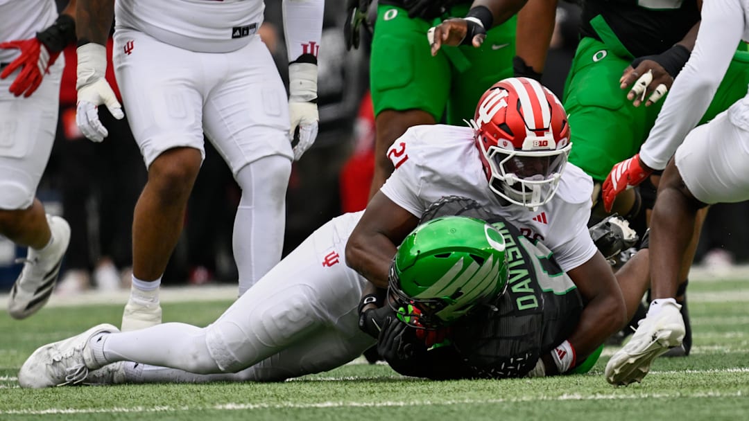 Oct 11, 2025; Eugene, Oregon, USA; Indiana Hoosiers linebacker Rolijah Hardy (21) tackles Oregon Ducks running back Jordon Davison (0) during the second quarter at Autzen Stadium. Mandatory Credit: Troy Wayrynen-Imagn Images