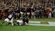 Sep 26, 2025; Charlottesville, Virginia, USA; Virginia Cavaliers defensive back Ja'son Prevard (10) is hugged by Cavaliers defensive back Donavon Platt (28) as fans storm the field after making a game winning interception in the end zone on a pass intended for Florida State Seminoles wide receiver Squirrel White (4) in the second overtime at Scott Stadium. Mandatory Credit: Geoff Burke-Imagn Images
