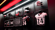 University of Cincinnati football player uniforms hang on the wall of the team locker room, Wednesday, June 11, 2025, at Sheakley Indoor Performance Center in Cincinnati.