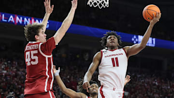 Jan 25, 2025; Fayetteville, Arkansas, USA; Arkansas Razorbacks forward Karter Knox (11) shoots in the second half as Oklahoma Sooners forward Luke Northweather (45) defends at Bud Walton Arena. Oklahoma won 65-62. Mandatory Credit: Nelson Chenault-Imagn Images