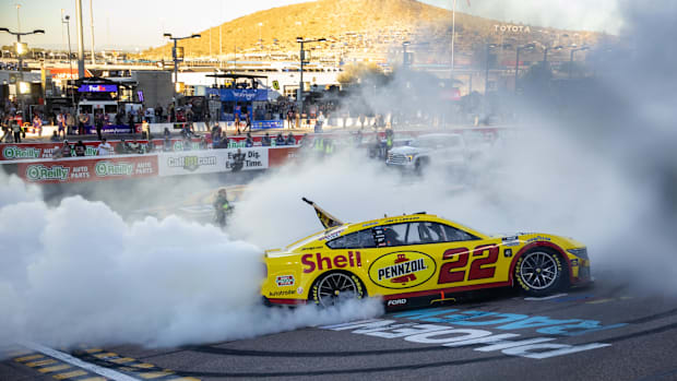 Joey Logano celebrates after winning the 2024 NASCAR Cup Series championship and the NASCAR Cup Series Championship race.