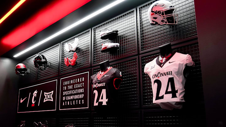 University of Cincinnati football player uniforms hang on the wall of the team locker room, Wednesday, June 11, 2025, at Sheakley Indoor Performance Center in Cincinnati.