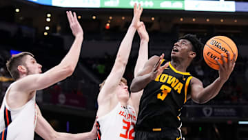 Iowa Hawkeyes guard Drew Thelwell (3) goes in for a lay-up against Illinois Fighting Illini guard Kasparas Jakucionis (32) on Thursday, March 13, 2025, during the second round of the men's Big Ten tournament at Gainbridge Fieldhouse in Indianapolis. The Illinois Fighting Illini defeated the Iowa Hawkeyes, 106-94.
