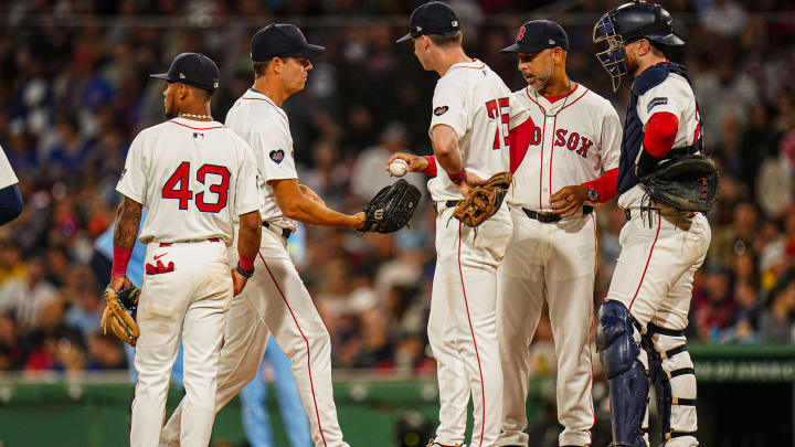 Aug 29, 2024; Boston, Massachusetts, USA; Boston Red Sox manager Alex Cora (13) hands over the ball to relief pitcher Rich Hill (44) in the seventh inning at Fenway Park. Mandatory Credit: David Butler II-USA TODAY Sports