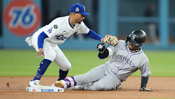 Apr 15, 2025; Los Angeles, California, USA; Colorado Rockies second baseman Adael Amador (1) is safe at second against Los Angeles Dodgers shortstop Mookie Betts (50) in the second inning at Dodger Stadium. All players wore #42 for Jackie Robinson Day. Mandatory Credit: Kirby Lee-Imagn Images