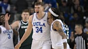 Feb 4, 2025; Los Angeles, California, USA; UCLA Bruins guard Skyy Clark (55) and forward Tyler Bilodeau (34) celebrate after a basket during the second half against the Michigan State Spartans at Pauley Pavilion presented by Wescom. Mandatory Credit: Jayne Kamin-Oncea-Imagn Images