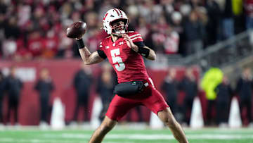 Nov 22, 2025; Madison, Wisconsin, USA; Wisconsin Badgers quarterback Carter Smith (5) throws a pass during the first quarter against the Illinois Fighting Illini at Camp Randall Stadium. Mandatory Credit: Kayla Wolf-Imagn Images