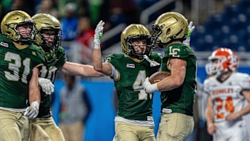 Sean Walicki (9) of Jackson Lumen Christi celebrates with his teammates after scoring a touchdown against Kingsley during the second half of the MHSAA Division 6 football state championship at Ford Field in Detroit on Friday, Nov. 28, 2025.