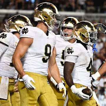 Aug 31, 2024; College Station, Texas, USA; Notre Dame Fighting Irish defensive lineman Joshua Burnham (4) celebrates with teammates after scoring a touchdown in the fourth quarter against the Texas A&M Aggies at Kyle Field. 