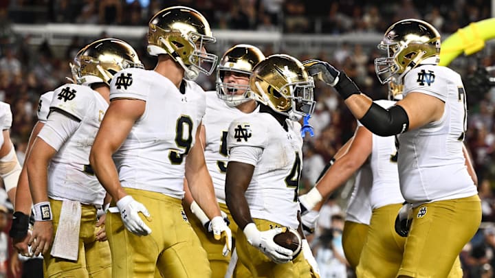 Aug 31, 2024; College Station, Texas, USA; Notre Dame Fighting Irish defensive lineman Joshua Burnham (4) celebrates with teammates after scoring a touchdown in the fourth quarter against the Texas A&M Aggies at Kyle Field. Mandatory Credit: Maria Lysaker-Imagn Images