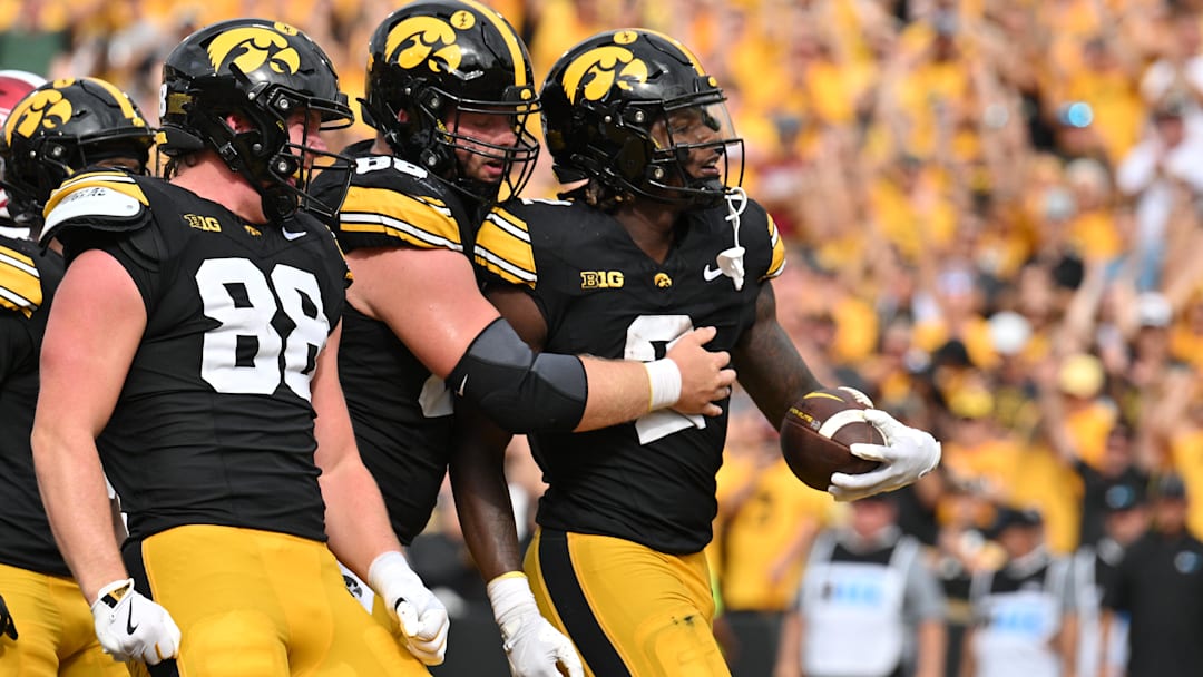 Sep 14, 2024; Iowa City, Iowa, USA; Iowa Hawkeyes running back Kaleb Johnson (2) reacts with fullback Hayden Large (88) and offensive lineman Logan Jones (65) after running for a 4 yard touchdown against the Troy Trojans during the second quarter at Kinnick Stadium. Mandatory Credit: Jeffrey Becker-Imagn Images