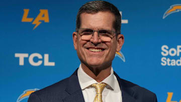 Feb 1, 2024; Inglewood, CA, USA; Los Angeles Chargers coach Jim Harbaugh poses with helmet at