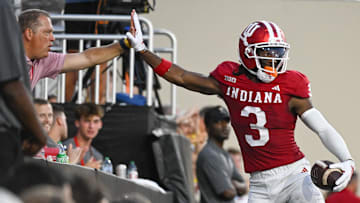 Sep 12, 2025; Bloomington, Indiana, USA; Indiana Hoosiers wide receiver Omar Cooper Jr. (3) celebrates with a fan after a touchdown during the first half against the Indiana State Sycamores at Memorial Stadium. Mandatory Credit: Robert Goddin-Imagn Images