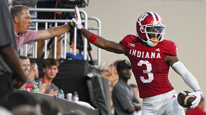Sep 12, 2025; Bloomington, Indiana, USA; Indiana Hoosiers wide receiver Omar Cooper Jr. (3) celebrates with a fan after a touchdown during the first half against the Indiana State Sycamores at Memorial Stadium. Mandatory Credit: Robert Goddin-Imagn Images