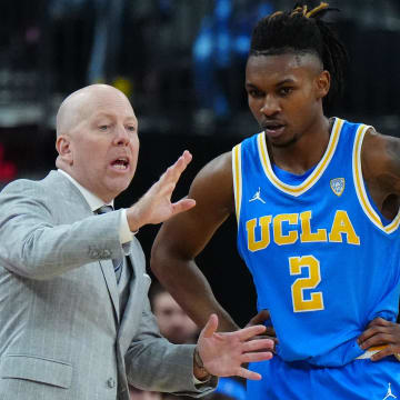 Mar 14, 2024; Las Vegas, NV, USA; UCLA Bruins head coach Mick Cronin (left) talks with guard Dylan Andrews (2) against the Oregon Ducks in the first half at T-Mobile Arena.