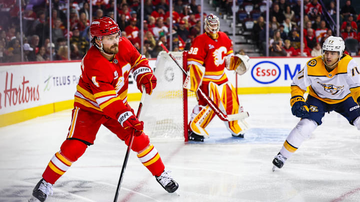 Jan 3, 2026; Calgary, Alberta, CAN; Calgary Flames defenseman Rasmus Andersson (4) controls the puck against the Nashville Predators during the third period at Scotiabank Saddledome. Mandatory Credit: Sergei Belski-Imagn Images