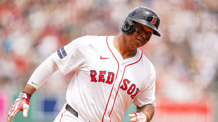 Jun 30, 2024; Boston, Massachusetts, USA; Boston Red Sox third baseman Rafael Devers (11) hits a two run home run against the San Diego Padres in the first inning at Fenway Park.