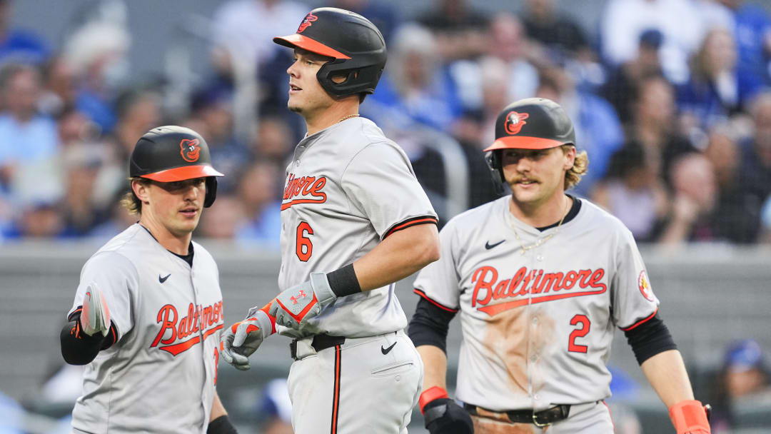 Ryan Mountcastle, Gunnar Henderson and Adley Rutschman celebrating in a road game at Rogers Center