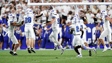 The BYU defense celebrates as Tyler Batty snags an interception against Kansas State.