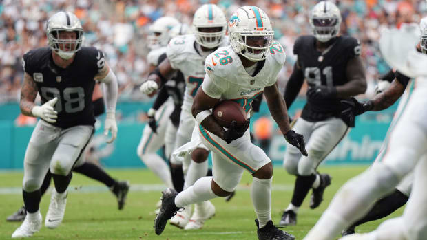 Ex-Husky running back Salvon Ahmed (26) picks up yards for the Miami Dolphins last season against the Las Vegas Raiders.