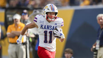 Sep 21, 2024; Morgantown, West Virginia, USA; Kansas Jayhawks wide receiver Luke Grimm (11) catches a pass and runs for a touchhdown during the fourth quarter against the West Virginia Mountaineers at Mountaineer Field at Milan Puskar Stadium. Mandatory Credit: Ben Queen-Imagn Images