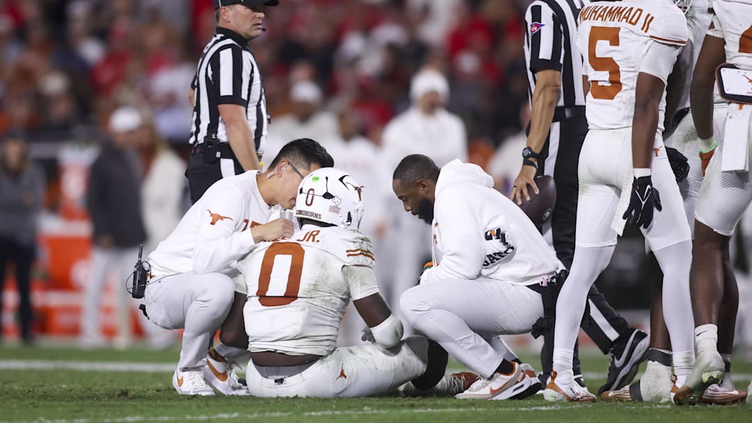 Nov 15, 2025; Athens, Georgia, USA; Texas Longhorns linebacker Anthony Hill Jr. (0 is assisted on the field during the second half against the Georgia Bulldogs at Sanford Stadium. Mandatory Credit: Brett Davis-Imagn Images