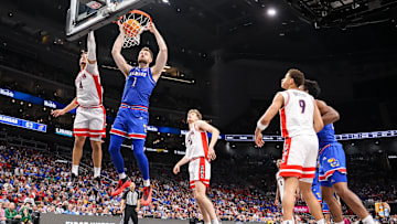 Mar 13, 2025; Kansas City, MO, USA; Kansas Jayhawks center Hunter Dickinson (1) dunks around Arizona Wildcats forward Trey Townsend (4) during the second half at T-Mobile Center. Mandatory Credit: William Purnell-Imagn Images