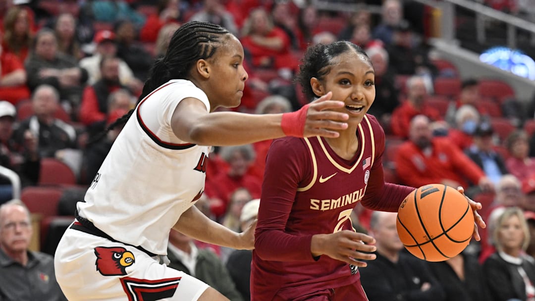 Feb 15, 2026; Louisville, Kentucky, USA;  Florida State Seminoles guard Amaya Bonner (2) dribbles against Louisville Cardinals forward MacKenly Randolph (4) during the second half at KFC Yum! Center. Louisville defeated Florida State 88-65. Mandatory Credit: Jamie Rhodes-Imagn Images