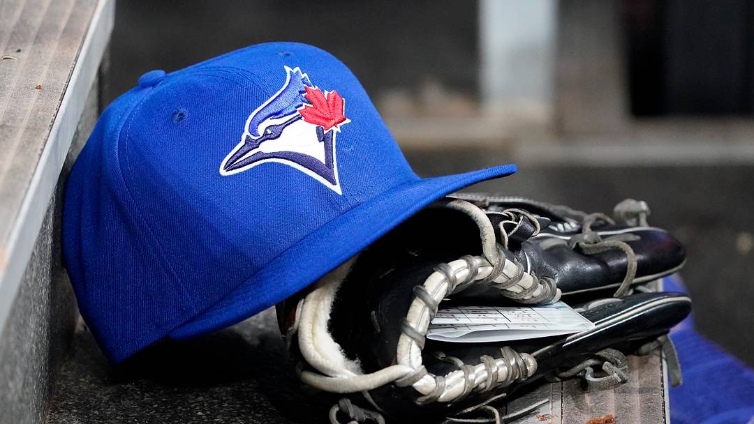 A Toronto Blue Jays hat and glove. Mandatory Credit: John E. Sokolowski-Imagn Images