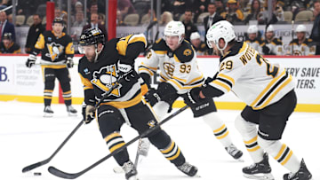 Apr 13, 2025; Pittsburgh, Pennsylvania, USA;  Pittsburgh Penguins right wing Bryan Rust (17) handles the puck  Boston Bruins center Fraser Minten (93) and Boston Bruins defenseman Parker Wotherspoon (29) defend during the third period at PPG Paints Arena. Mandatory Credit: Charles LeClaire-Imagn Images