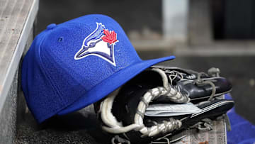 Apr 16, 2025; Toronto, Ontario, CAN; A Toronto Blue Jays hat and glove in the dugout during a game against the Atlanta Braves at Rogers Centre. 