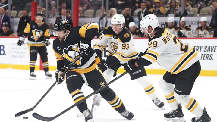 Apr 13, 2025; Pittsburgh, Pennsylvania, USA;  Pittsburgh Penguins right wing Bryan Rust (17) handles the puck  Boston Bruins center Fraser Minten (93) and Boston Bruins defenseman Parker Wotherspoon (29) defend during the third period at PPG Paints Arena. Mandatory Credit: Charles LeClaire-Imagn Images