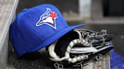 Apr 16, 2025; Toronto, Ontario, CAN; A Toronto Blue Jays hat and glove in the dugout during a game against the Atlanta Braves at Rogers Centre. 