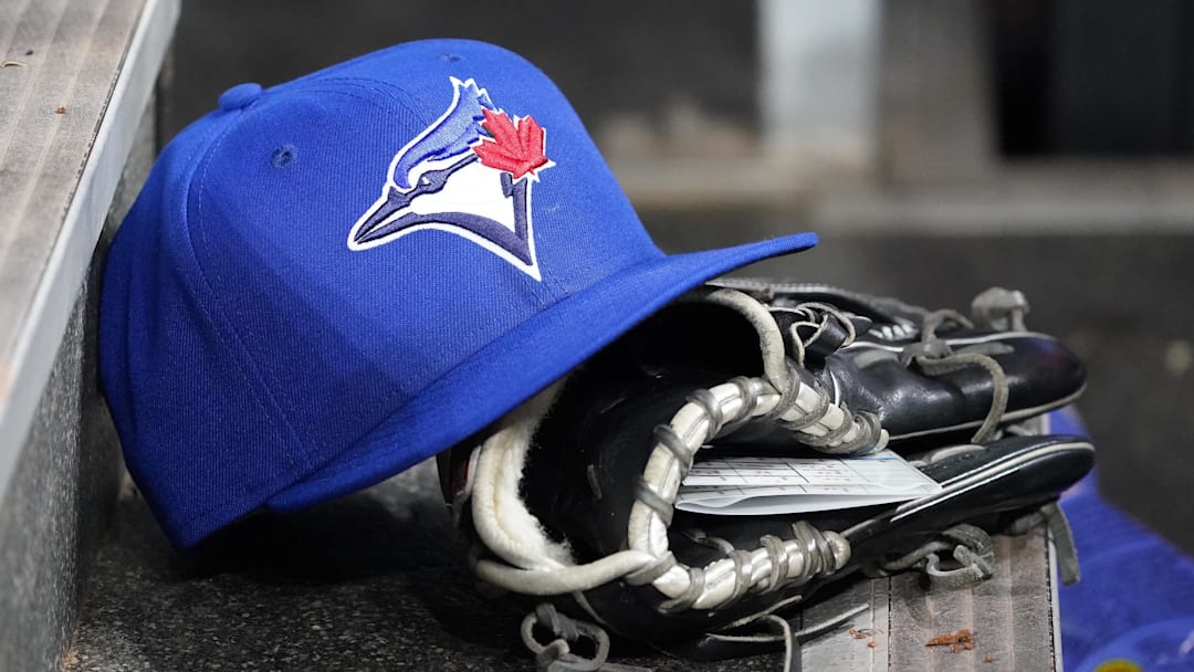 Apr 16, 2025; Toronto, Ontario, CAN; A Toronto Blue Jays hat and glove in the dugout during a game against the Atlanta Braves at Rogers Centre.