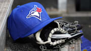 Apr 16, 2025; Toronto, Ontario, CAN; A Toronto Blue Jays hat and glove in the dugout during a game against the Atlanta Braves at Rogers Centre. 