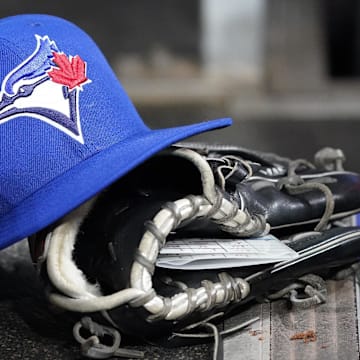 Apr 16, 2025; Toronto, Ontario, CAN; A Toronto Blue Jays hat and glove in the dugout during a game against the Atlanta Braves at Rogers Centre. 