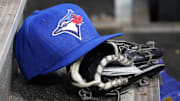 Apr 16, 2025; Toronto, Ontario, CAN; A Toronto Blue Jays hat and glove in the dugout during a game against the Atlanta Braves at Rogers Centre. 