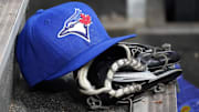 Apr 16, 2025; Toronto, Ontario, CAN; A Toronto Blue Jays hat and glove in the dugout during a game against the Atlanta Braves at Rogers Centre. 