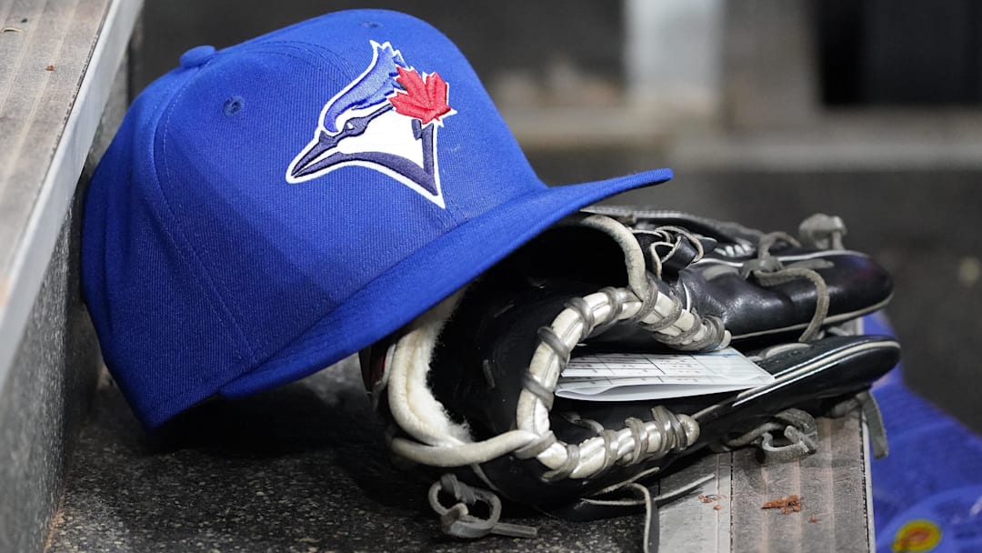 Apr 16, 2025; Toronto, Ontario, CAN; A Toronto Blue Jays hat and glove in the dugout during a game against the Atlanta Braves at Rogers Centre.