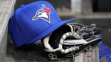 Apr 16, 2025; Toronto, Ontario, CAN; A Toronto Blue Jays hat and glove in the dugout during a game against the Atlanta Braves at Rogers Centre. 
