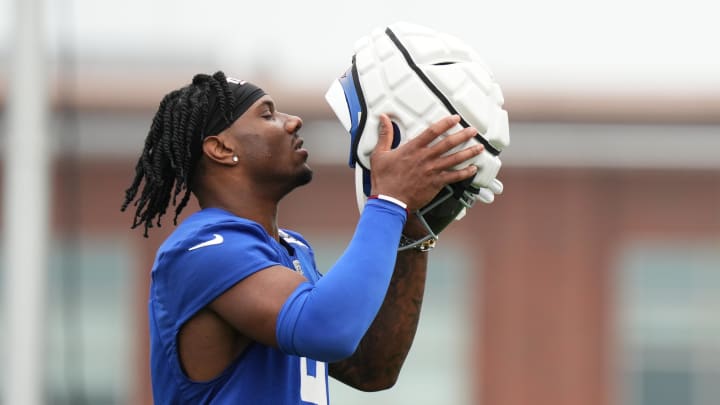 Jul 25, 2024; East Rutherford, NY, USA; New York Giants wide receiver Malik Nabers (9) puts on his helmet during training camp at Quest Diagnostics Training Center.  